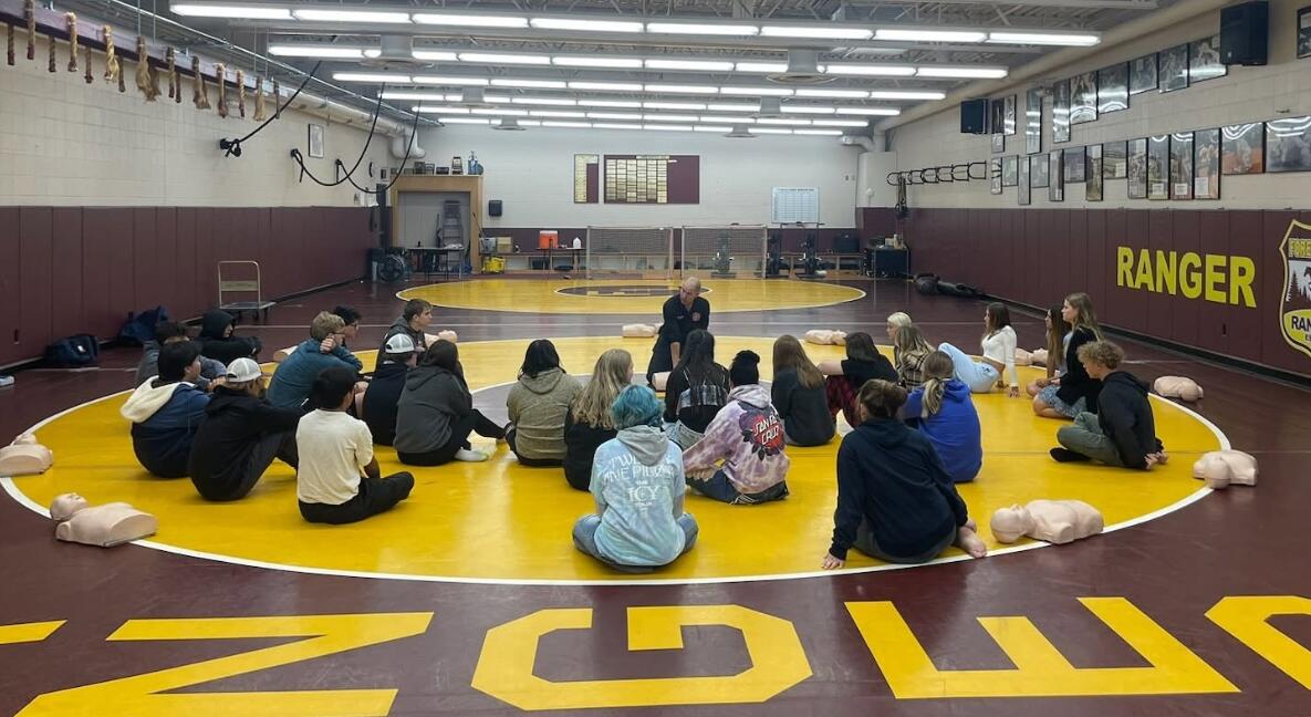 Sean Thomas teaching CPR to a group of students