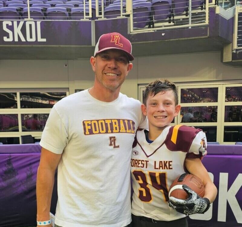 Sean Thomas with his son Hudson after a football game