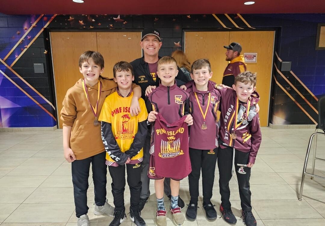 Sean Thomas with young wrestlers and their medals